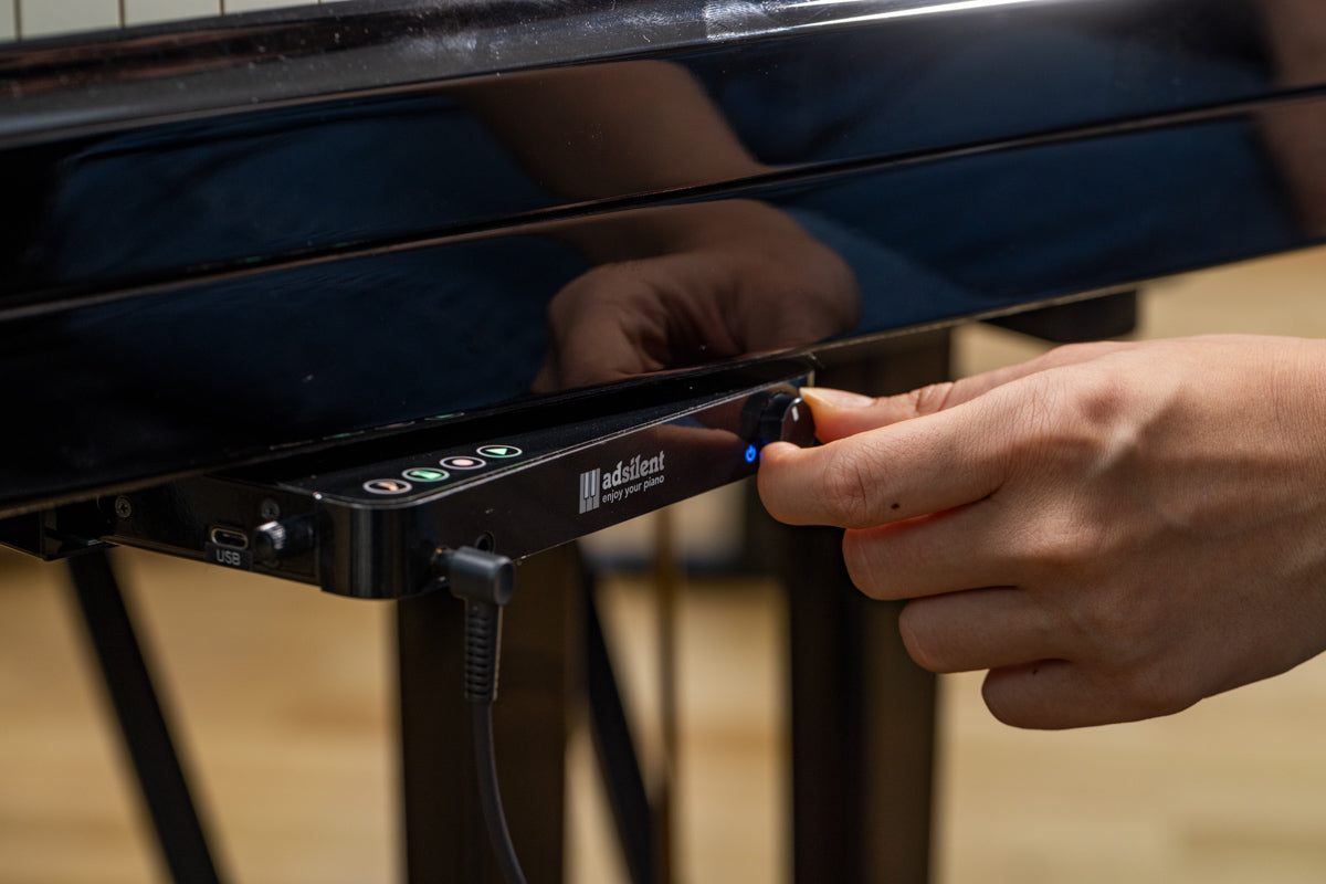 Système Adsilent pour pianos à queue